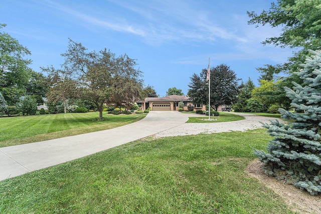 view of front of home with driveway, a garage, and a front yard