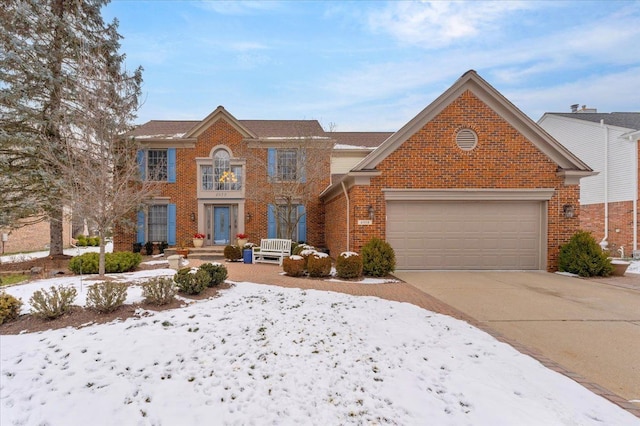 view of front of home with a garage, concrete driveway, and brick siding