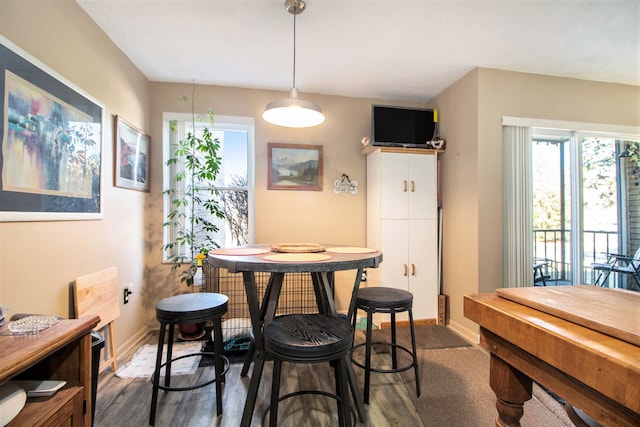 dining room with dark wood finished floors and baseboards