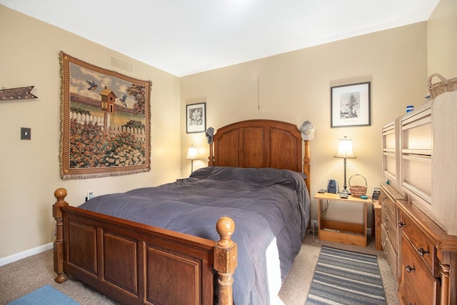 carpeted bedroom featuring baseboards and visible vents