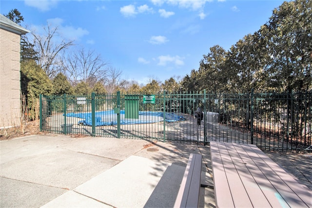 view of swimming pool featuring fence and a patio