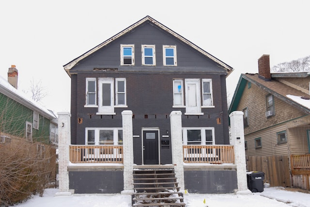 view of front facade featuring brick siding and fence