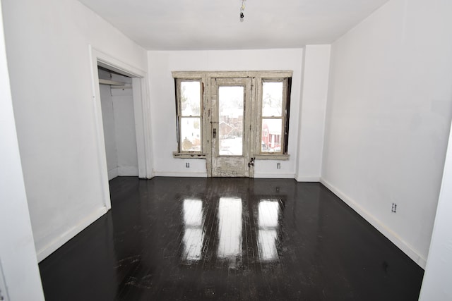 interior space featuring dark wood-style floors and baseboards