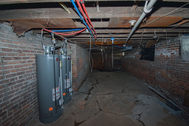 unfinished basement featuring gas water heater and brick wall