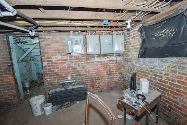 unfinished below grade area featuring brick wall and electric panel