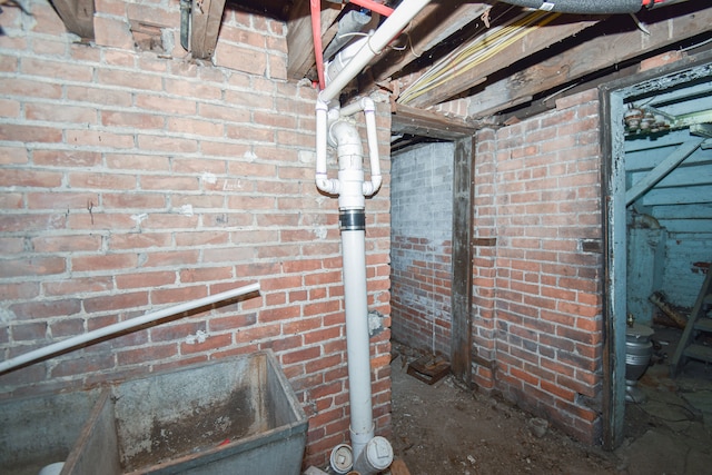 unfinished basement featuring brick wall