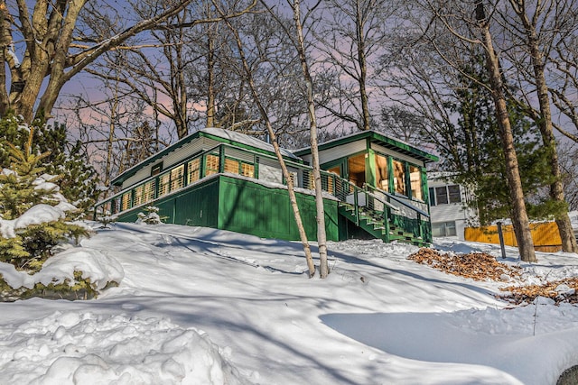 view of front of house featuring driveway and stairway