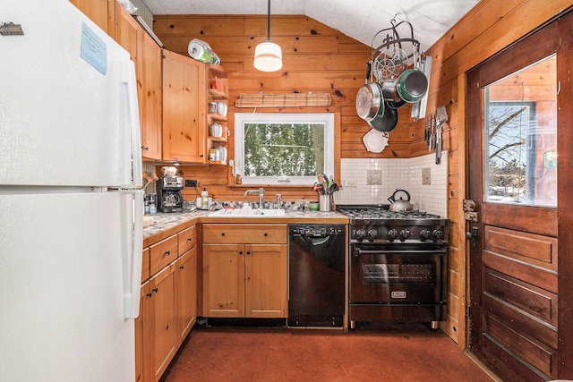 kitchen featuring black dishwasher, hanging light fixtures, light countertops, high end stainless steel range, and freestanding refrigerator