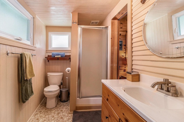 full bath featuring toilet, a shower stall, vanity, and wooden walls