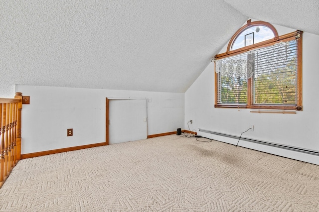 bonus room featuring carpet, lofted ceiling, a baseboard heating unit, a textured ceiling, and baseboards