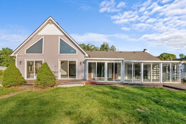 back of house with a sunroom and a yard