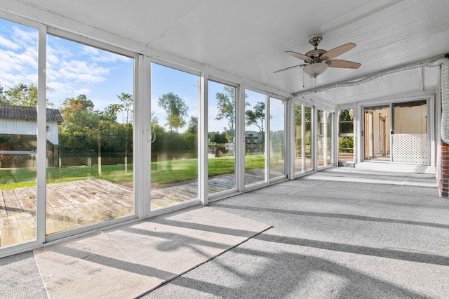 unfurnished sunroom with a ceiling fan