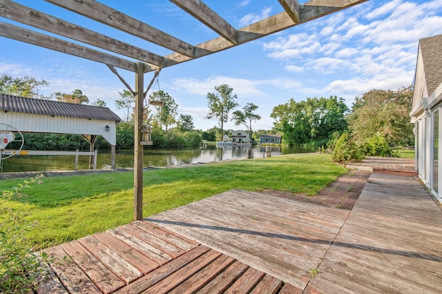 wooden deck featuring a lawn, a water view, and a pergola