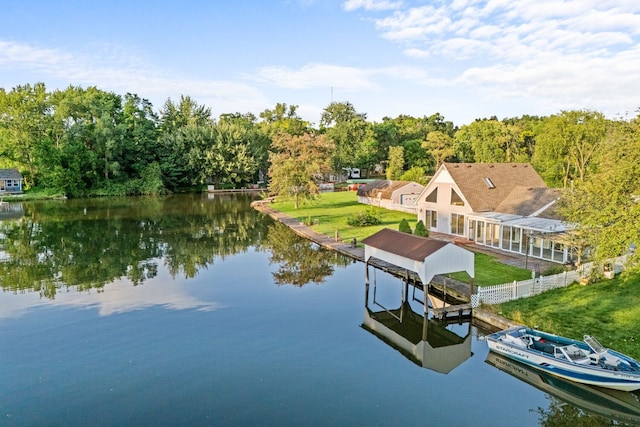 exterior space featuring a water view, boat lift, and a yard