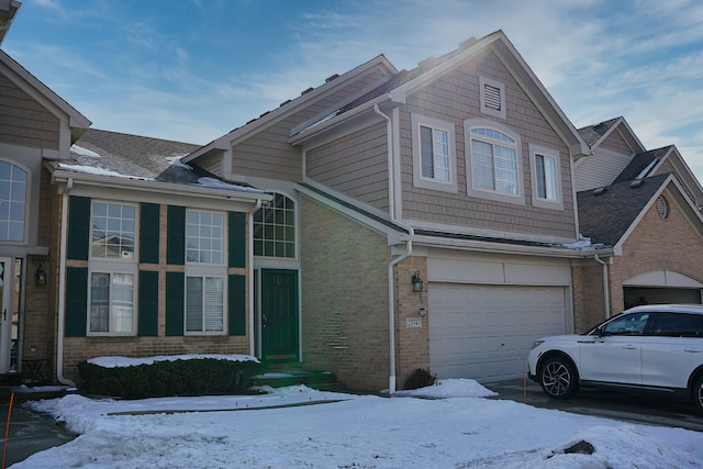 view of front facade featuring a garage and brick siding