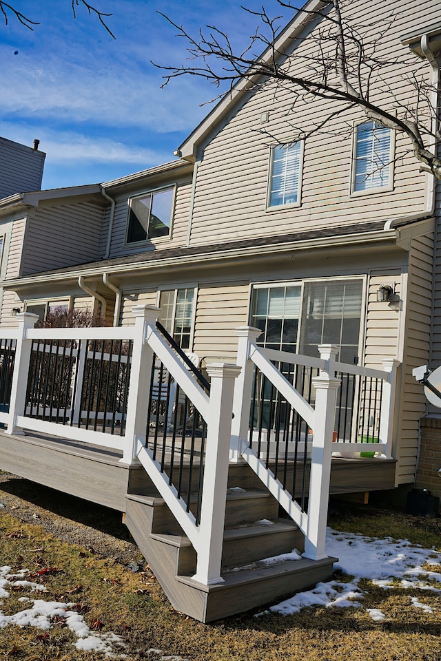 back of house with a deck