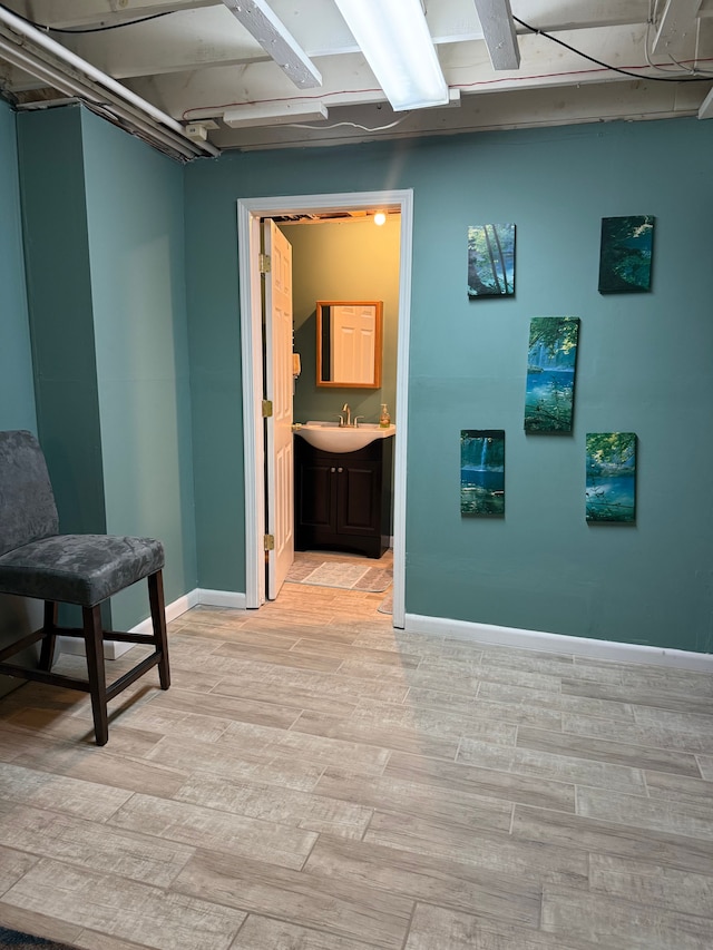 interior space with wood finish floors and baseboards