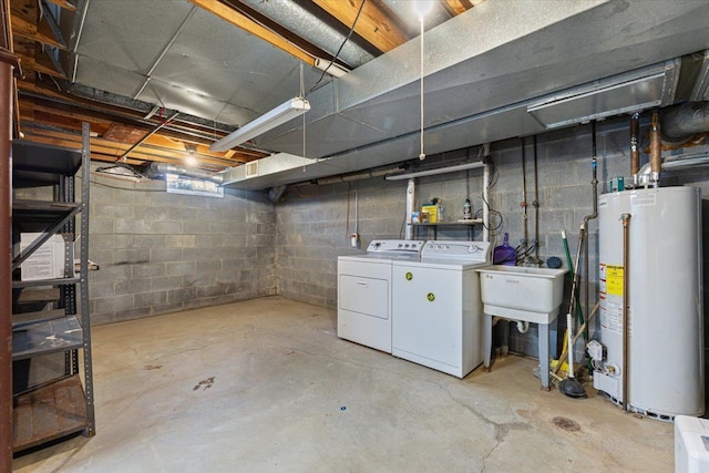 unfinished below grade area featuring gas water heater and washing machine and clothes dryer