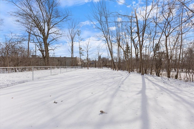 yard layered in snow featuring fence