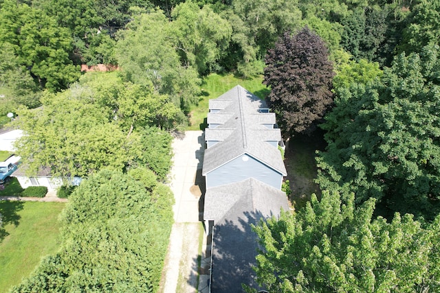 drone / aerial view featuring a forest view