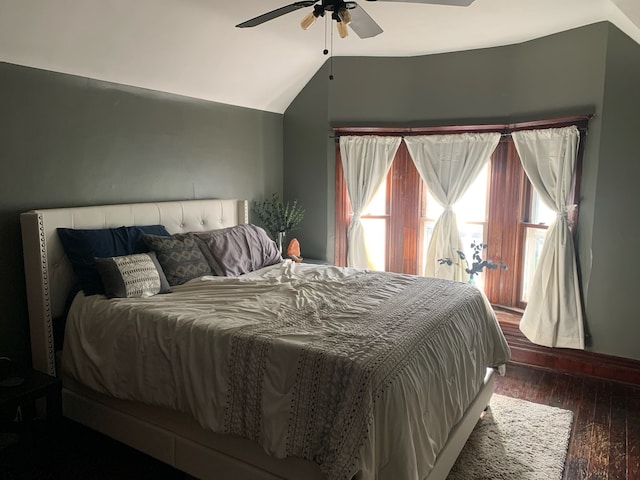 bedroom with a ceiling fan, lofted ceiling, and wood finished floors