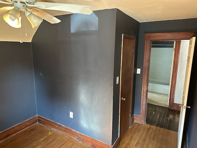 unfurnished room featuring baseboards, wood-type flooring, and ceiling fan