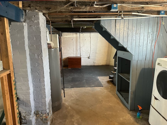 unfinished basement featuring washer / clothes dryer and water heater