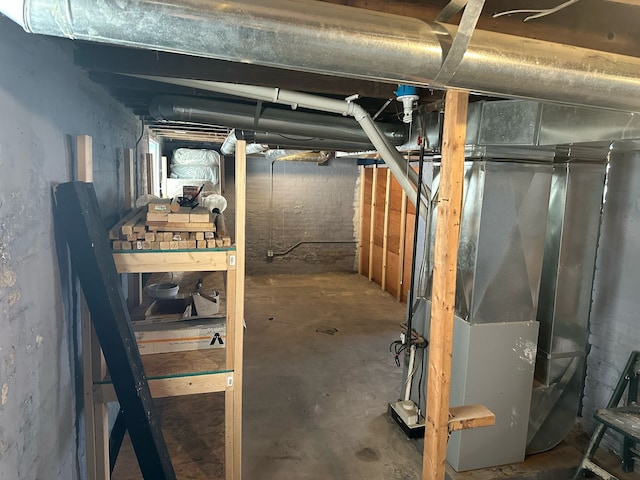 unfinished basement featuring heating unit