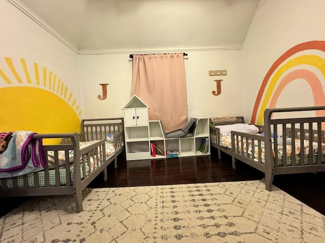 bedroom featuring vaulted ceiling and wood finished floors