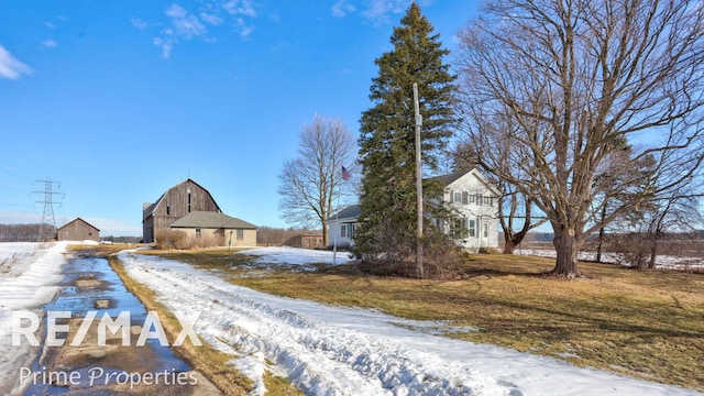 view of road featuring a barn and driveway