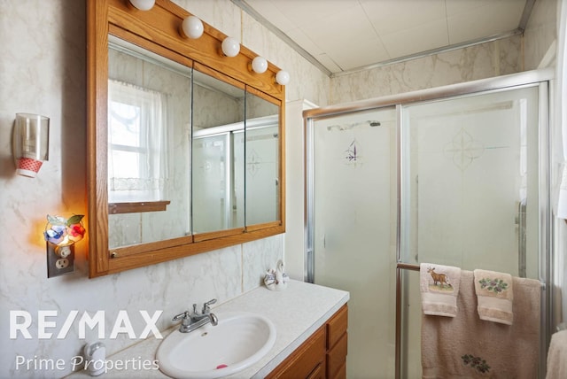 bathroom featuring a stall shower and vanity