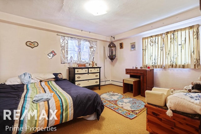 carpeted bedroom with a baseboard radiator