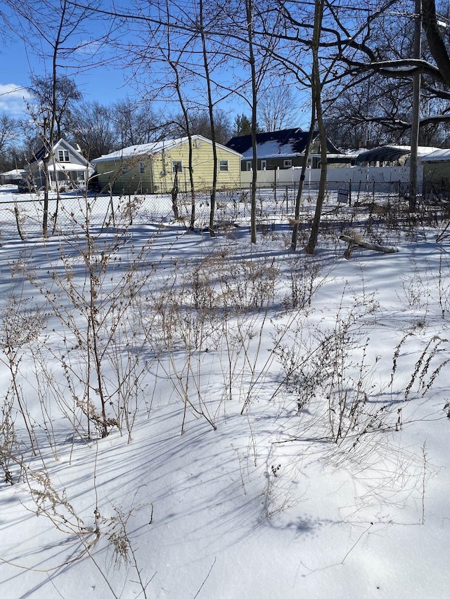 yard covered in snow with fence