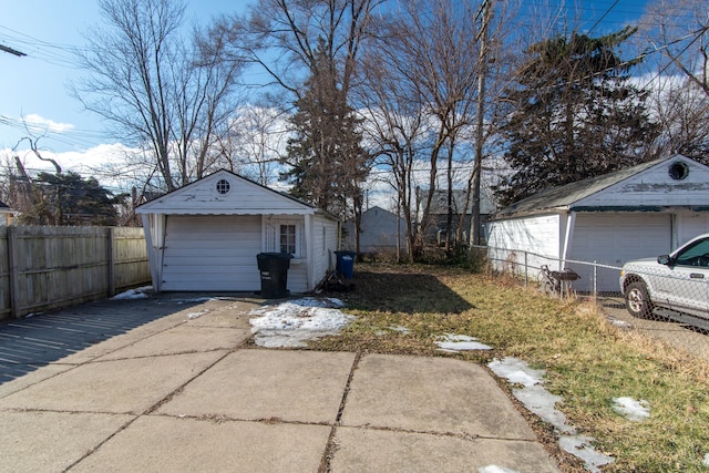 detached garage featuring fence