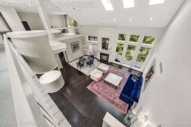 28036 Hickory Cir, Farmington Hills, MI 48331 - living room with high vaulted ceiling, a skylight, a glass covered fireplace, wood finished floors, and recessed lighting