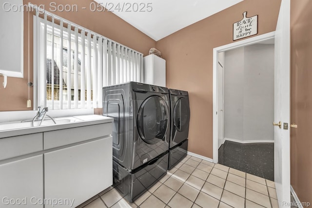 28036 Hickory Cir, Farmington Hills, MI 48331 - laundry area with washer and dryer, light tile patterned floors, and baseboards