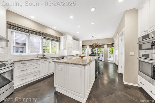 28036 Hickory Cir, Farmington Hills, MI 48331 - kitchen featuring stainless steel appliances, plenty of natural light, a kitchen island, white cabinetry, and recessed lighting