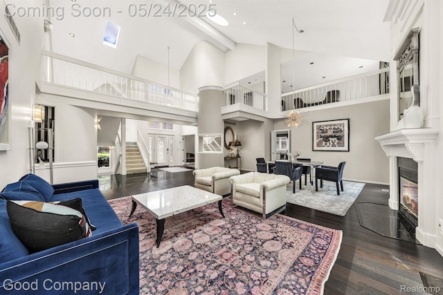 28036 Hickory Cir, Farmington Hills, MI 48331 - living area featuring a glass covered fireplace, wood finished floors, high vaulted ceiling, baseboards, and stairway