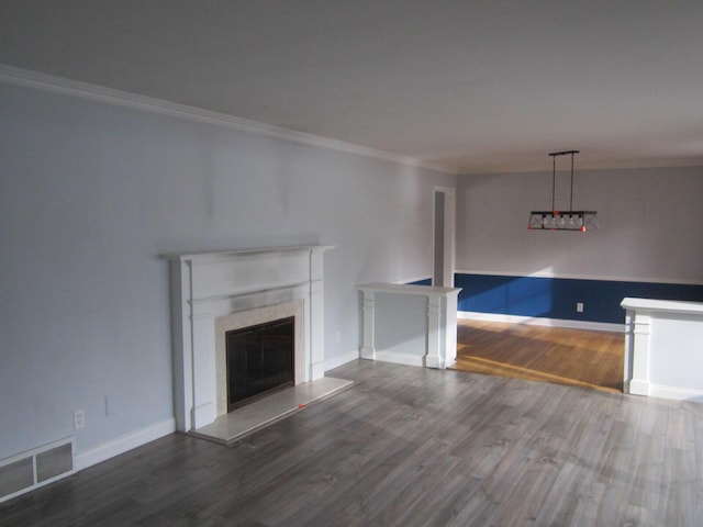 unfurnished living room with visible vents, ornamental molding, dark wood-style flooring, and a high end fireplace