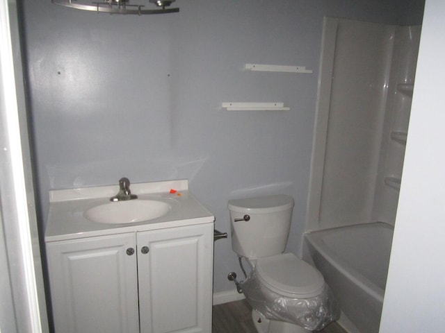 bathroom featuring toilet, wood finished floors, and vanity