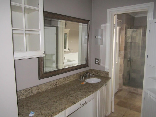 bathroom featuring a shower stall and vanity