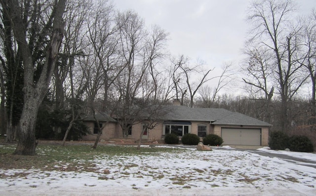 view of front of home with a garage and a chimney