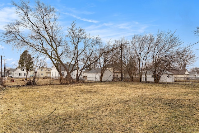 view of yard featuring a residential view and fence