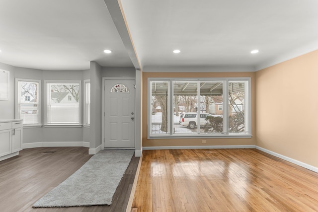 entryway with light wood-type flooring, plenty of natural light, and baseboards