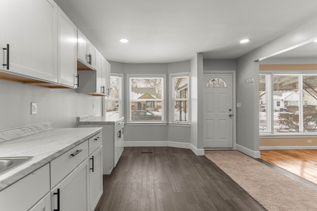 kitchen with baseboards, recessed lighting, dark wood finished floors, and white cabinets