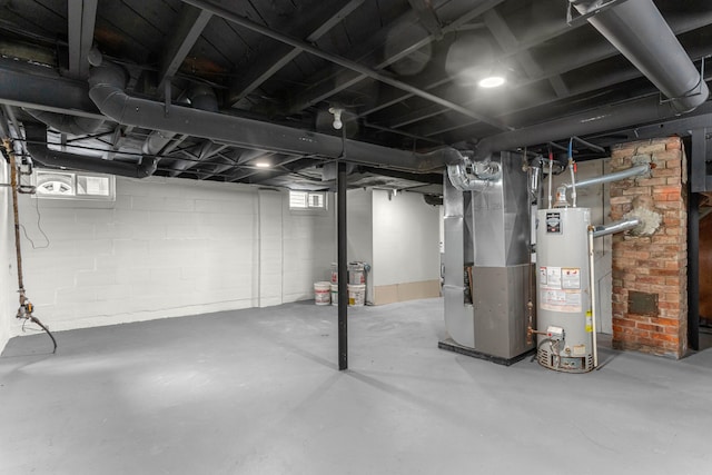 basement featuring gas water heater and heating unit