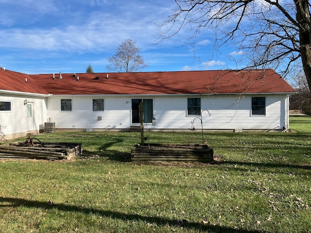 back of house featuring central AC and a yard