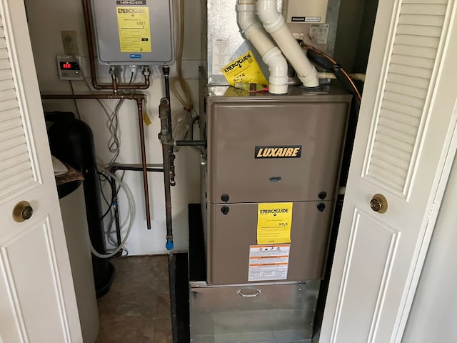 utility room featuring tankless water heater