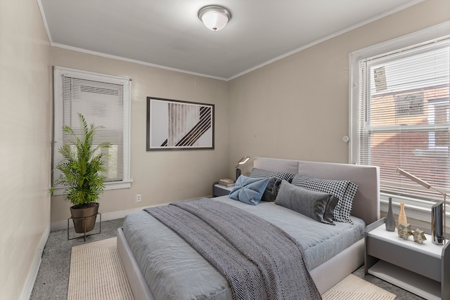 bedroom featuring crown molding, carpet flooring, and baseboards