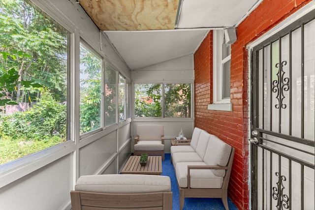 sunroom / solarium featuring lofted ceiling